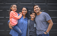 Portait of smiling hispanic family standing