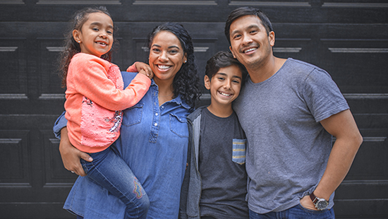 Portait of smiling hispanic family standing